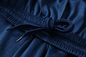 Macro detail shot showing the elastic waistband and matching drawstring of a navy football jersey