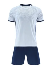 Detailed view of breathable jacquard soccer jersey and shorts in white and navy blue