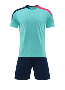 Turquoise and navy blue soccer training uniform set featuring pink shoulder accents
