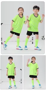 Detail view of kids lime green soccer jersey set on models in studio background