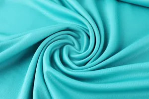 Gros plan détaillé sur le tissu en maille respirante bleu sarcelle pour les maillots