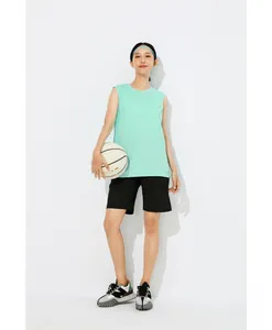 Athletic woman in mint green quick-dry sleeveless training vest with side slits