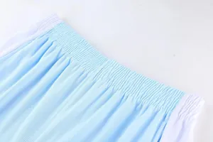 Close-up of the elastic waistband and mesh fabric on light blue sports basketball shorts