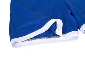 Dettaglio ravvicinato del tessuto a rete traspirante e dell'orlo sulla maglia blu