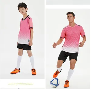 Detailed view of child and adult wearing pink gradient quick-dry soccer jerseys.