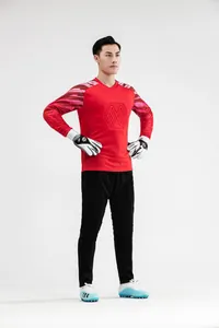 Full view of male model in red quick-dry goalkeeper jersey and black soccer pants