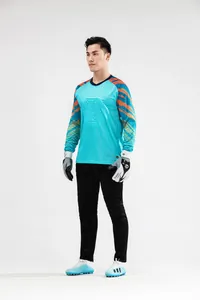 Full-body view of male goalkeeper wearing turquoise long-sleeve jersey and black training pants