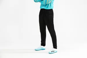 Side view of black padded goalkeeper pants for soccer training and match play.
