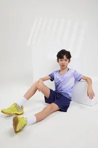 Detail shot of a boy wearing purple gradient badminton jersey with navy blue shorts