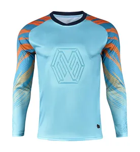 Detailed view of a light blue goalkeeper jersey featuring a hexagonal embossed chest logo