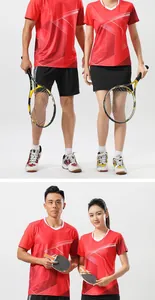 Sporty red athletic shirts for men and women with racket sports equipment shown in studio.