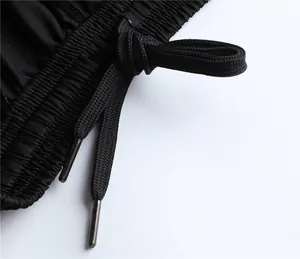 Close-up of black sports shorts elastic waistband with adjustable drawstring detail