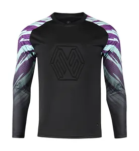 Close-up of black goalkeeper jersey with purple patterned sleeves and embossed chest logo
