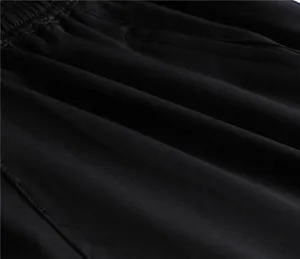 Close-up macro shot showing texture of unisex black breathable sports shorts fabric.