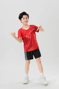 Kids red badminton competition jersey with geometric patterns and black athletic shorts