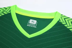 Detail of green soccer jersey collar with XL size tag and breathable fabric texture