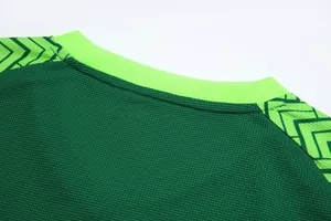 Close-up of green football jersey neckline showing breathable mesh fabric texture