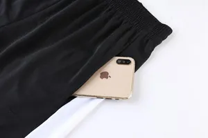 Close-up detail of breathable mesh sports shorts with a functional side pocket for phone