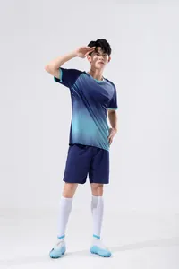 Full-body presentation of an athletic man wearing a navy blue soccer kit with cyan patterns