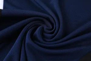 Macro view of dark blue breathable mesh fabric for professional quick-dry sportswear texture