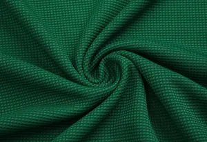 Close-up macro detail of green waffle knit fabric showing texture and pattern