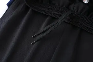 Close-up detail of black breathable mesh sports shorts with elastic drawstring waist