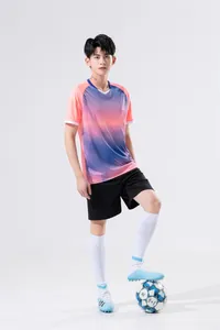 Male model wearing pink and purple gradient soccer training jersey and shorts set