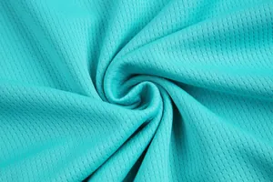 Close-up macro view of breathable turquoise mesh fabric used in high-quality basketball jerseys