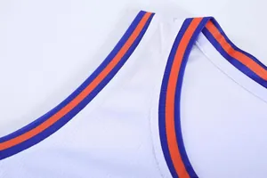 Close-up detail of white mesh basketball jersey with blue and orange collar trim.