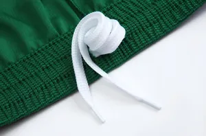 Macro detail showing the texture of green soccer jersey fabric and a white braided drawstring