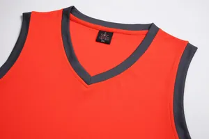 Detail of red V-neck basketball jersey with breathable mesh fabric and size tag