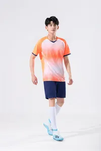 Male model wearing an orange and white gradient training sportswear set with shorts