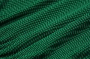 Macro view of green honeycomb texture fabric for breathable football training sets