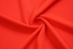 Macro view showing the breathable red mesh fabric texture of a basketball jersey