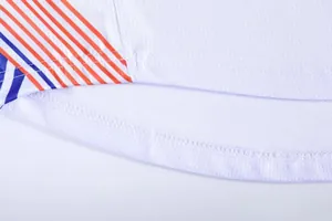 Detailed close-up view of the stitching and mesh fabric on a white basketball jersey's hem