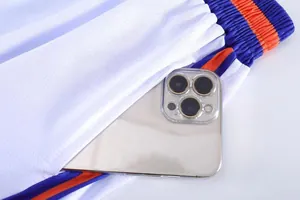 Close-up of side pocket on white mesh basketball shorts with phone for size reference
