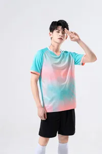 Full-body view of men's athletic training suit featuring a cyan and pink gradient jersey