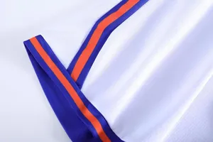 Close-up of white mesh basketball jersey with blue and orange striped trim detail