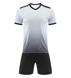 Full view of white to black gradient soccer jersey set with geometric patterns.
