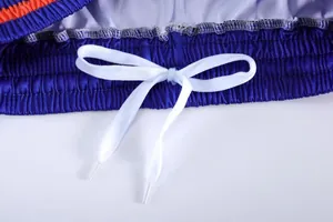 Close-up detail of the elastic waistband and white drawstring on blue sports basketball shorts
