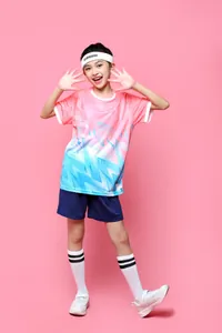 Girl in pink and blue gradient soccer jersey set with wave pattern on pink background