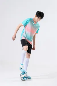 Men's athletic training set with gradient blue jersey and black shorts on model