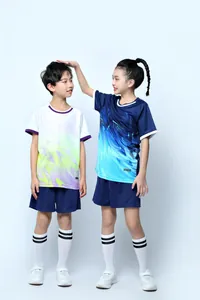 Kids wearing vibrant gradient summer soccer jersey sets with matching shorts and socks