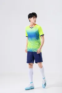 Male model in neon yellow and blue soccer training uniform set full shot