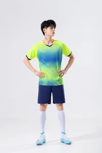Full-body view of male athlete in green and blue gradient soccer training uniform set
