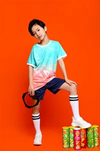 Full view of a youth summer soccer jersey set featuring cyan and pink gradient patterns