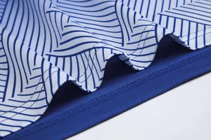 Close-up detail of breathable blue and white patterned soccer jersey fabric with stitching