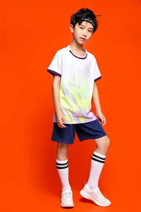 Young boy modeling a vibrant summer football jersey set with colorful geometric patterns