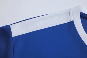 Detail of blue and white soccer jersey showing breathable mesh fabric and clean stitching