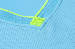 Detailed close-up of breathable mesh fabric on a blue basketball jersey with neon trim